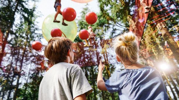 A family enjoys WOW PARK, a treetop playground in Denmark